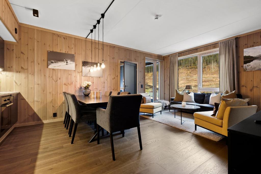 a dining room and living room with a table and chairs at Fyri Resort Nr 23 in Hemsedal