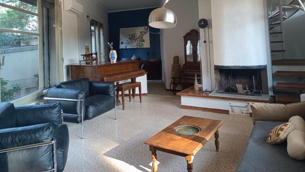 a living room with a couch and a piano at Villa Luce by Italy Home eXperience in Santa Marinella