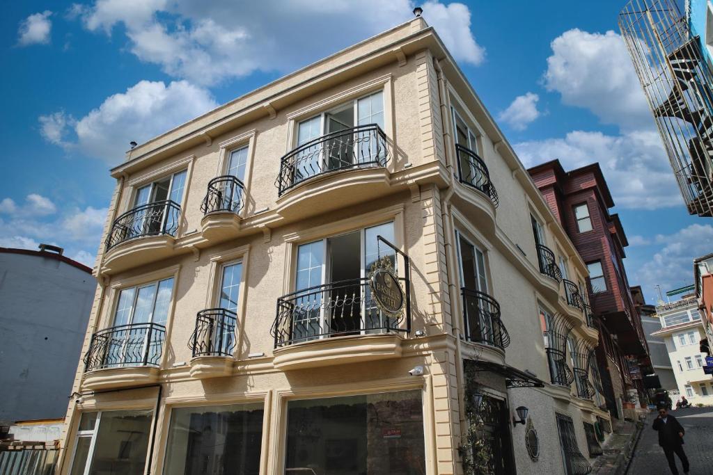 a white building with balconies on a city street at Basileus Hotel in Istanbul