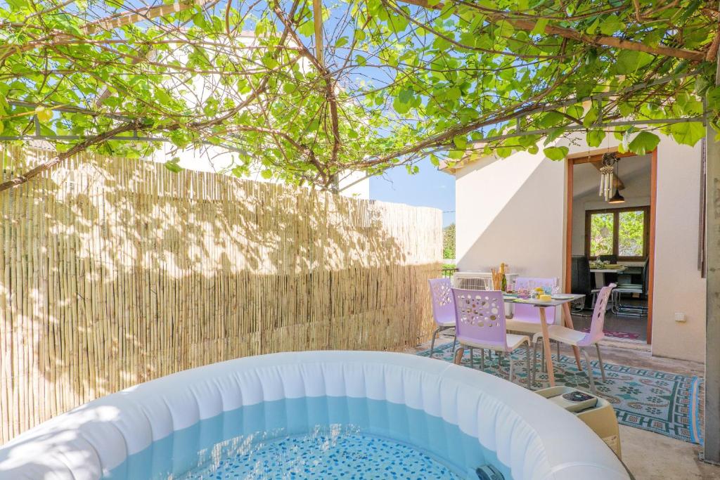 a hot tub in the backyard of a house at Gite en sud-ardèche avec jacuzzi in Joyeuse