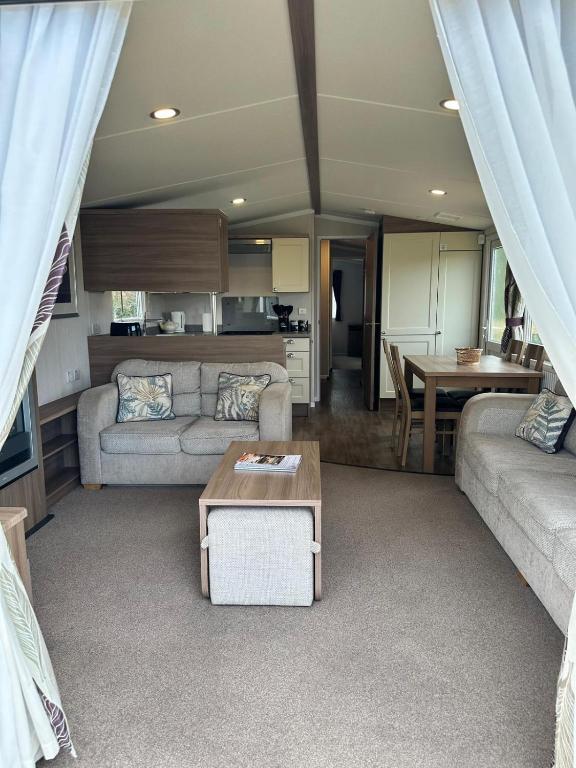 a living room with a couch and a table at Swift Bordeaux 56 in Dunoon