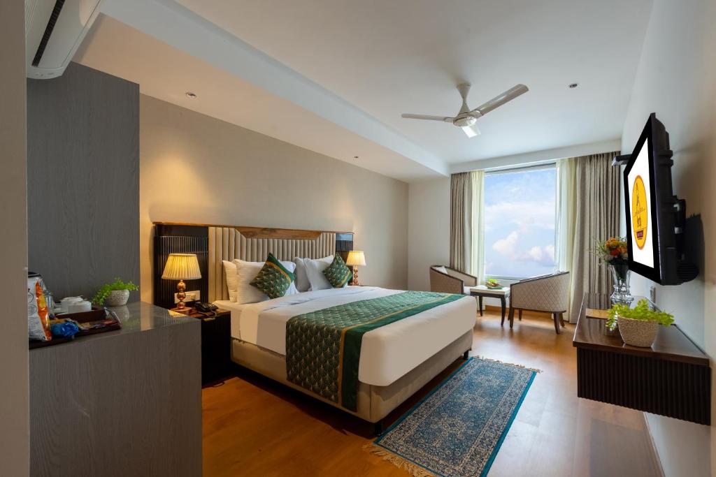a bedroom with a bed and a television in a room at The Lohias Premium - Delhi IGI Airport in New Delhi
