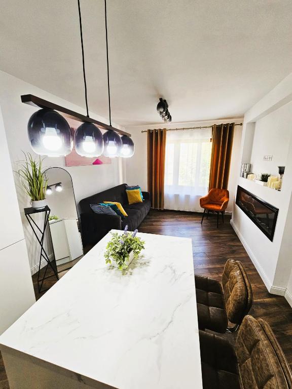 a living room with a white table and a couch at Concept Luxury in Mediaş