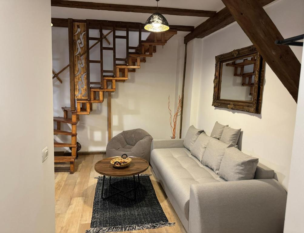 a living room with a couch and a table at Baritiu Apartment Brasov in Braşov