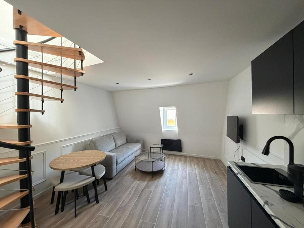 a living room with a couch and a table at Duplex moderne hyper-centre Tout à pied in Thonon-les-Bains
