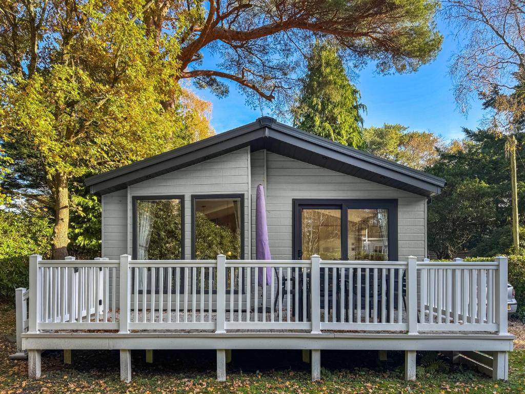 a small house with a white fence at Portland in Poole
