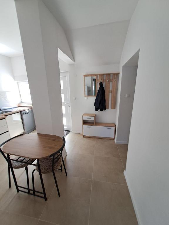 a dining room with a table and a kitchen at Apartment Kazela in Split
