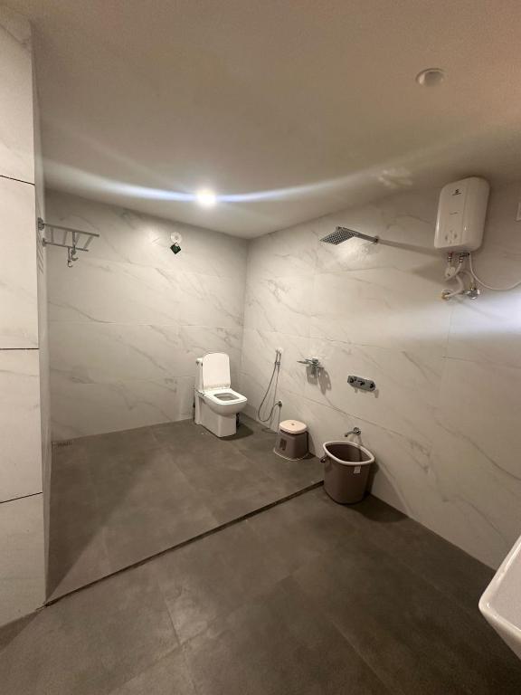 a bathroom with a toilet and a sink at Chandan resort in Chitrāwal