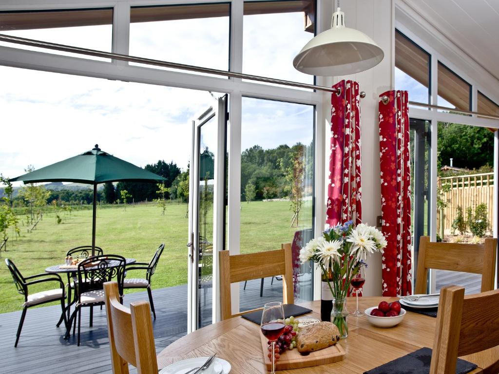 a dining room with a view of a yard at Willow Lodge in Hassocks