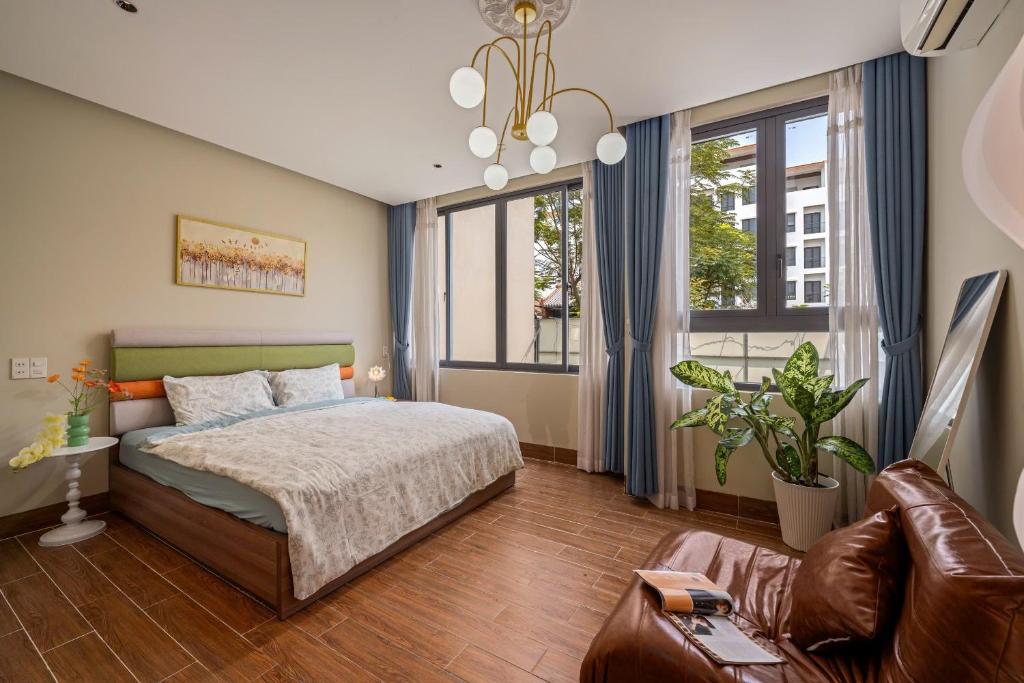 a bedroom with a bed and a large window at Doris Entire House Da Nang in Danang