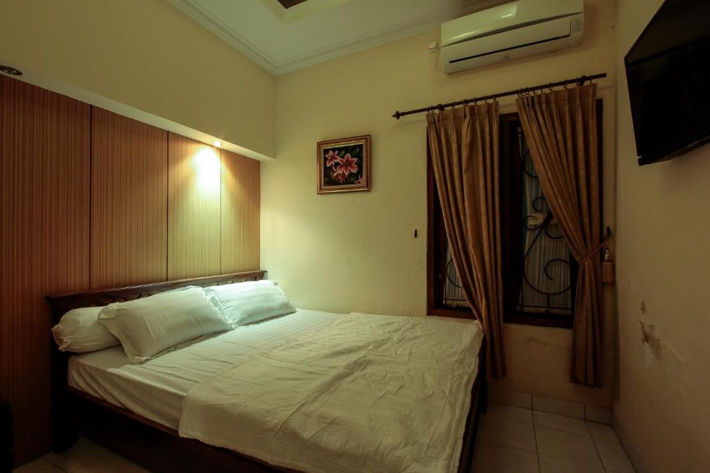 Postel nebo postele na pokoji v ubytování Griya Langen Guesthouse