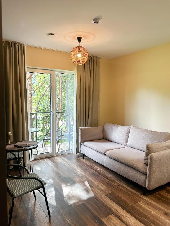 a living room with a couch and a table at 4 winds Notus in Palanga