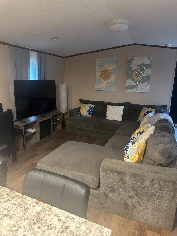 a living room with a couch and a flat screen tv at The Relaxation Haven 