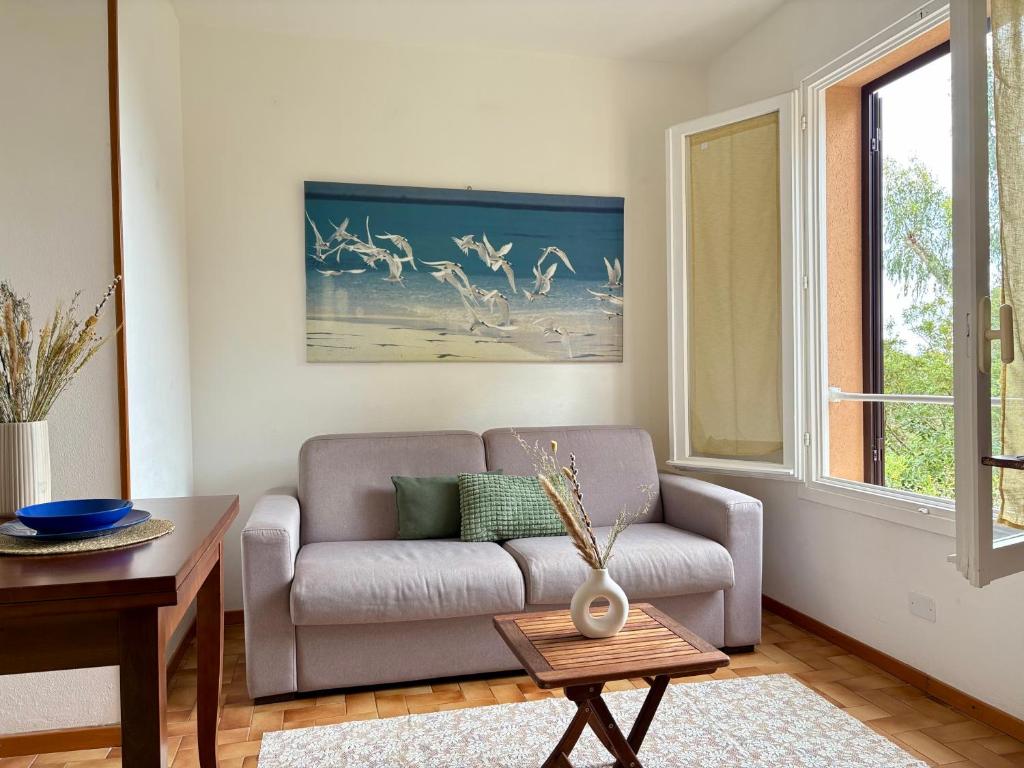 a living room with a couch and a table at Capo d'Arco Residence Bilocale tra Mare e Natura in Capo D'Arco