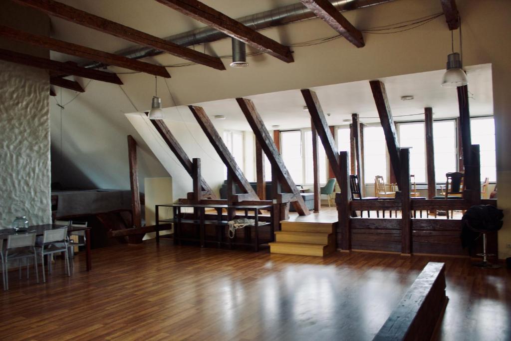 a large room with wooden floors and wooden beams at Skyview Hostel in Tallinn
