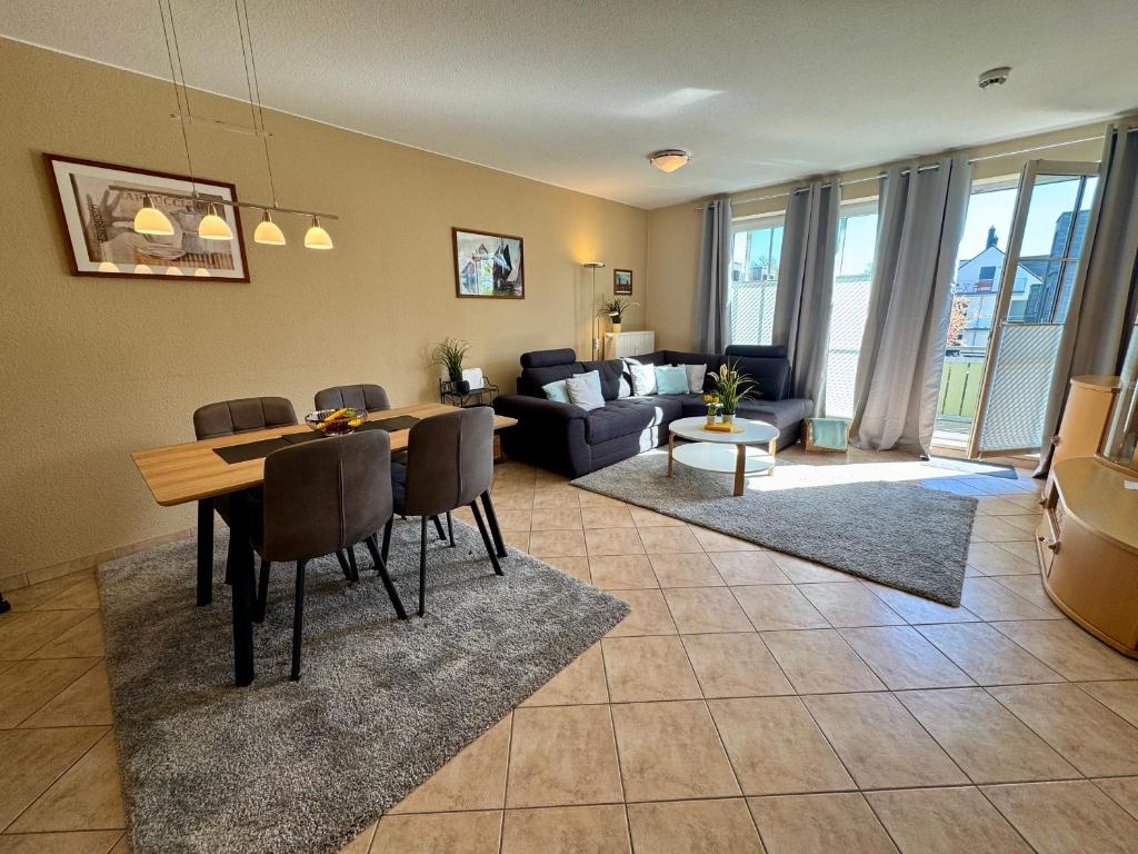 a living room with a dining table and a couch at Altes Wasserwerk App 22 in Wustrow