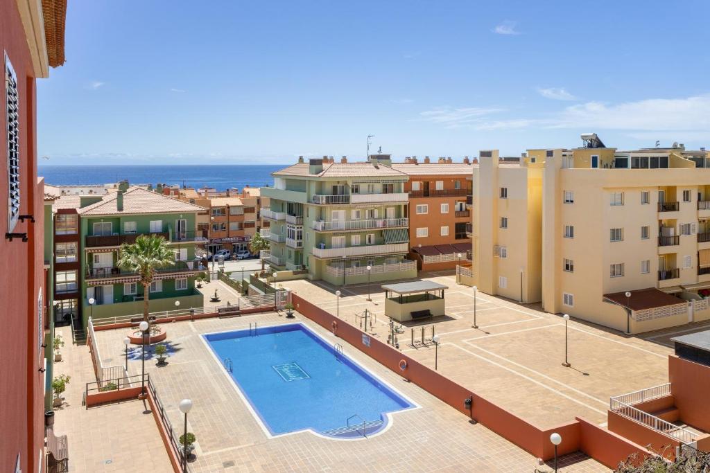 an apartment with a swimming pool and buildings at Olivia’s Beach in Candelaria