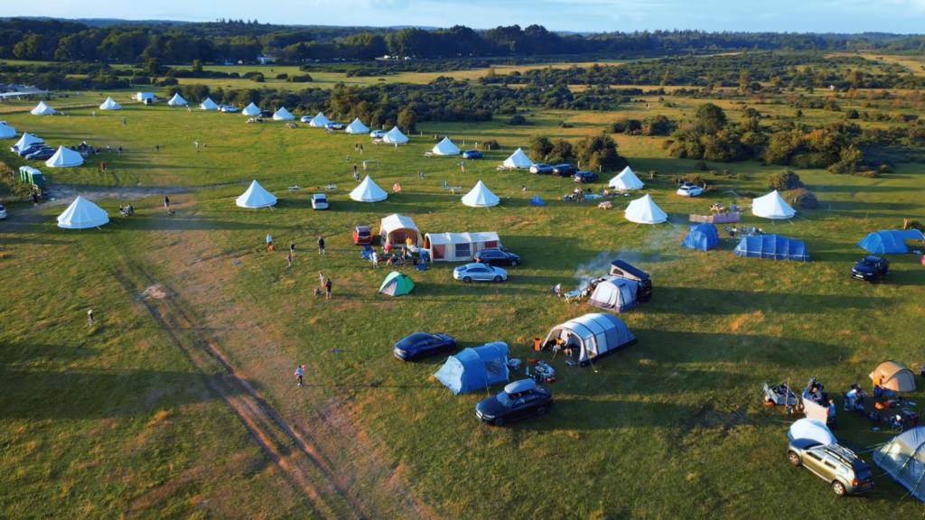 an aerial view of a group of tents in a field at The Old Airfield Campsite in Bransgore