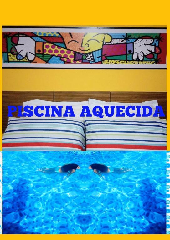 a swimming pool with two dolphins in the water at Flats e suítes Alegria in Olímpia