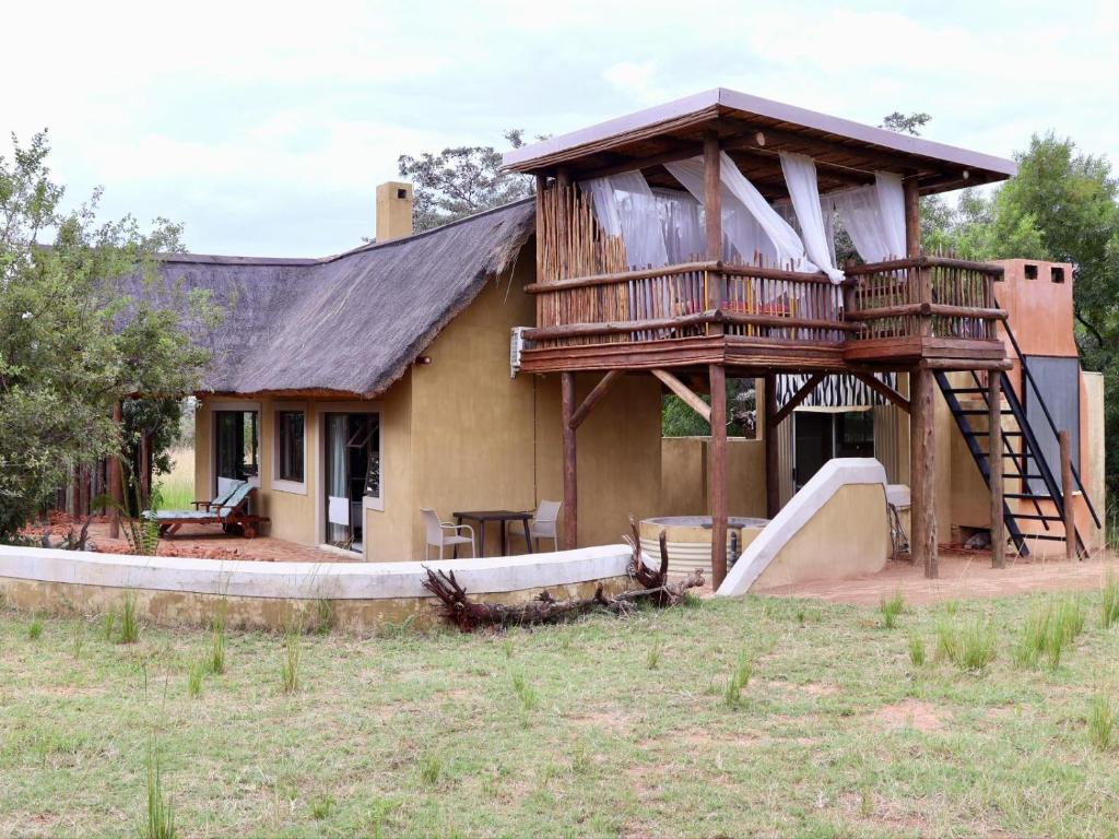 a house with a deck with a slide at Bushveld Venue in Mabula