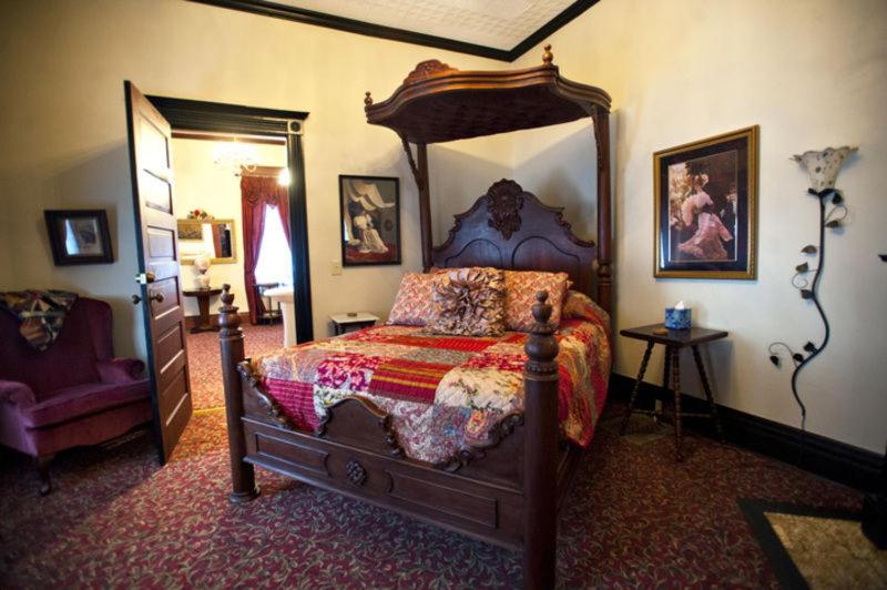 ein Schlafzimmer mit einem Himmelbett in der Unterkunft Grand Victorian Inn in Park City