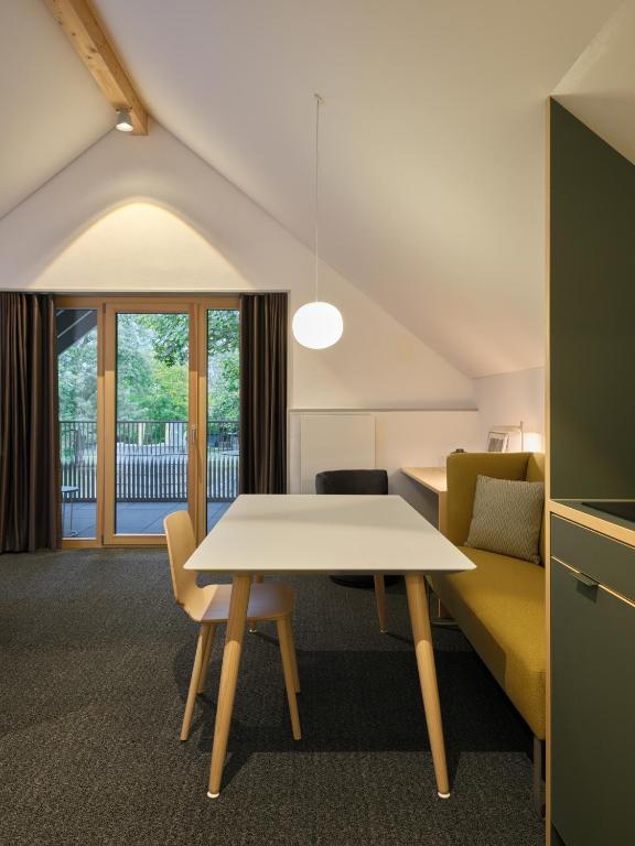 a living room with a table and a couch at Wohnen an der Mühlenwiese in Bad Sobernheim