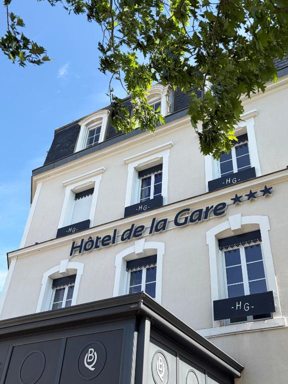 a building with a sign for a hospital die la care at Hôtel de la Gare - Restaurant Bistro Quai in La Roche-sur-Yon