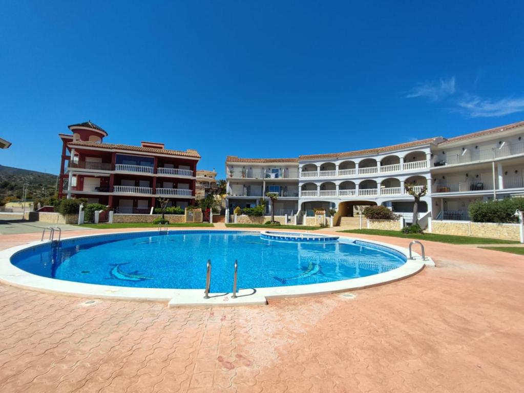 a large swimming pool in front of a building at Sueno de Peniscola in Peniscola