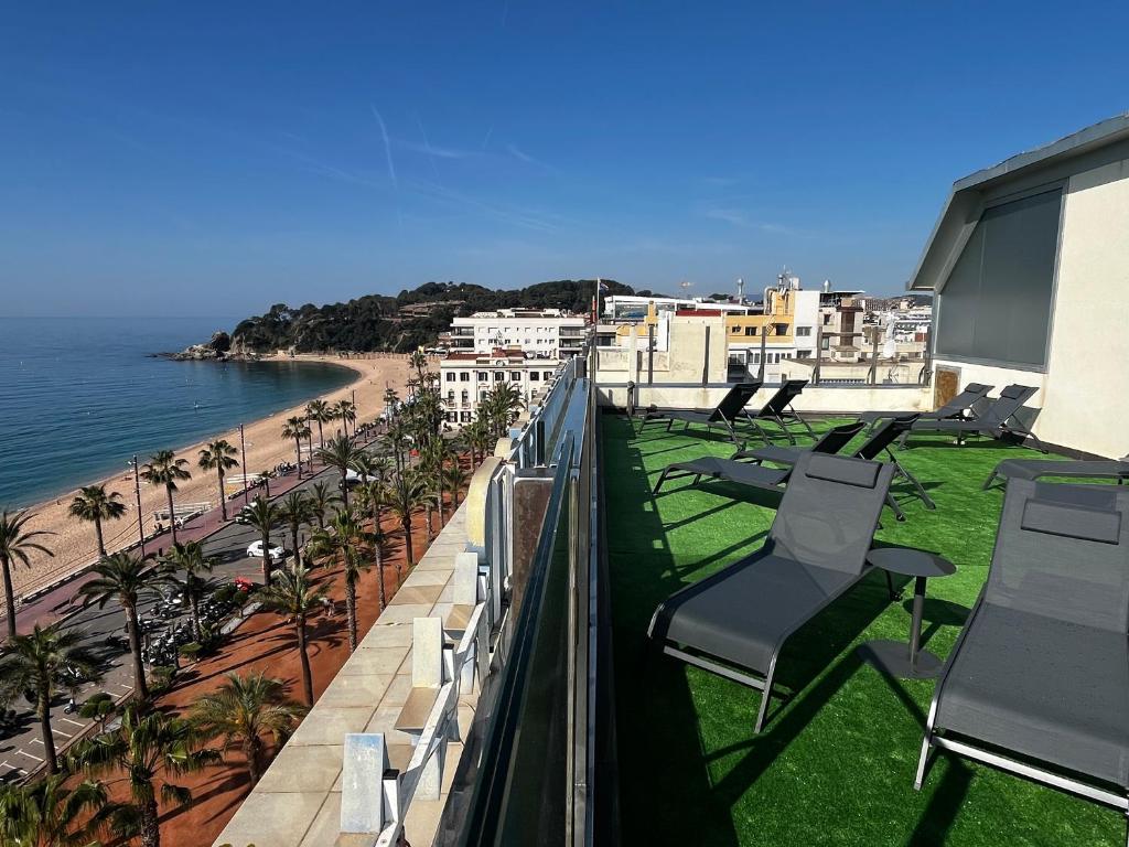 a balcony with chairs and a view of the beach at Hotel Excelsior in Lloret de Mar
