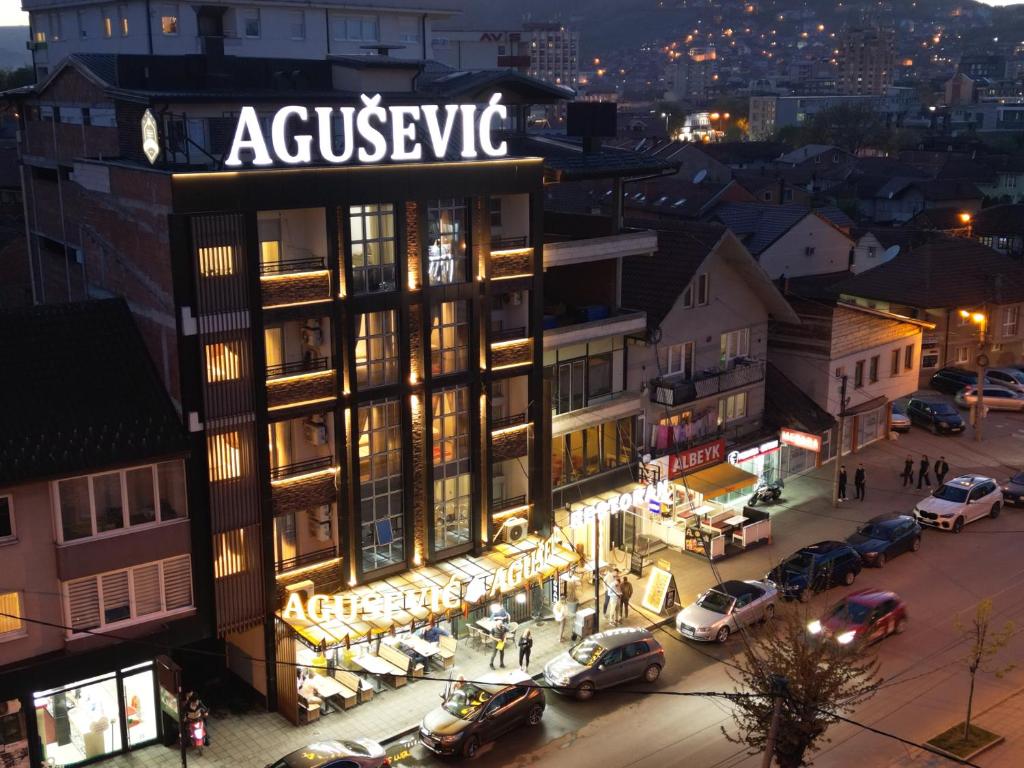 a building with a sign on top of it at Agušević Home in Novi Pazar
