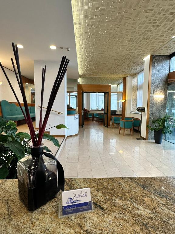 a vase sitting on a counter in a lobby at Hotel Cristallo in Udine