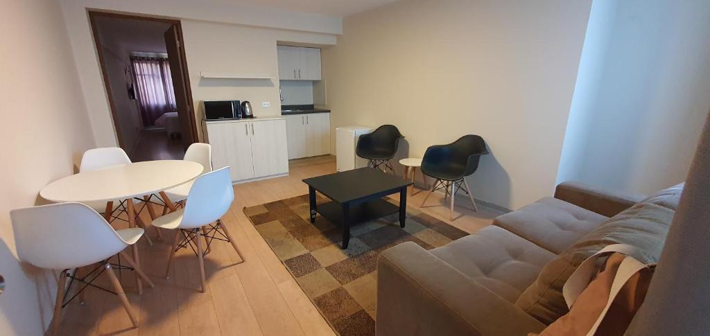 a living room with a couch and a table and chairs at Apartamentos San Martín in San Antonio