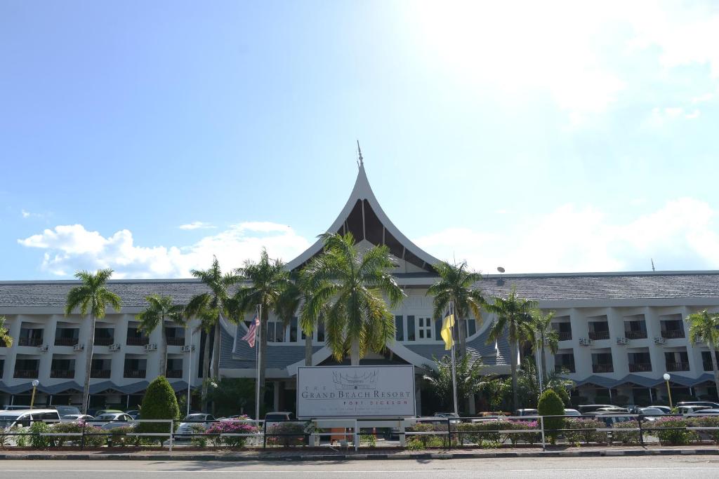 a large building with a sign in front of it at The Grand Beach Resort Port Dickson in Port Dickson