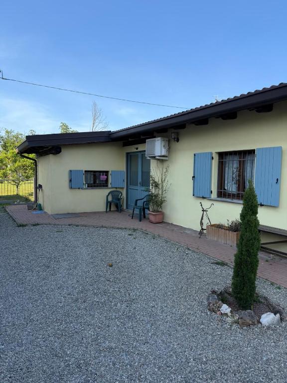 a house with a gravel driveway in front of it at Casotta Luca in Vigevano