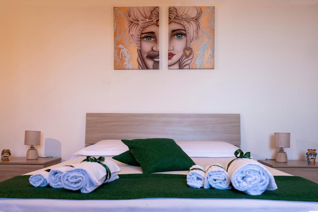 a bedroom with a bed with a picture of a woman at Taormina Matthome in Taormina