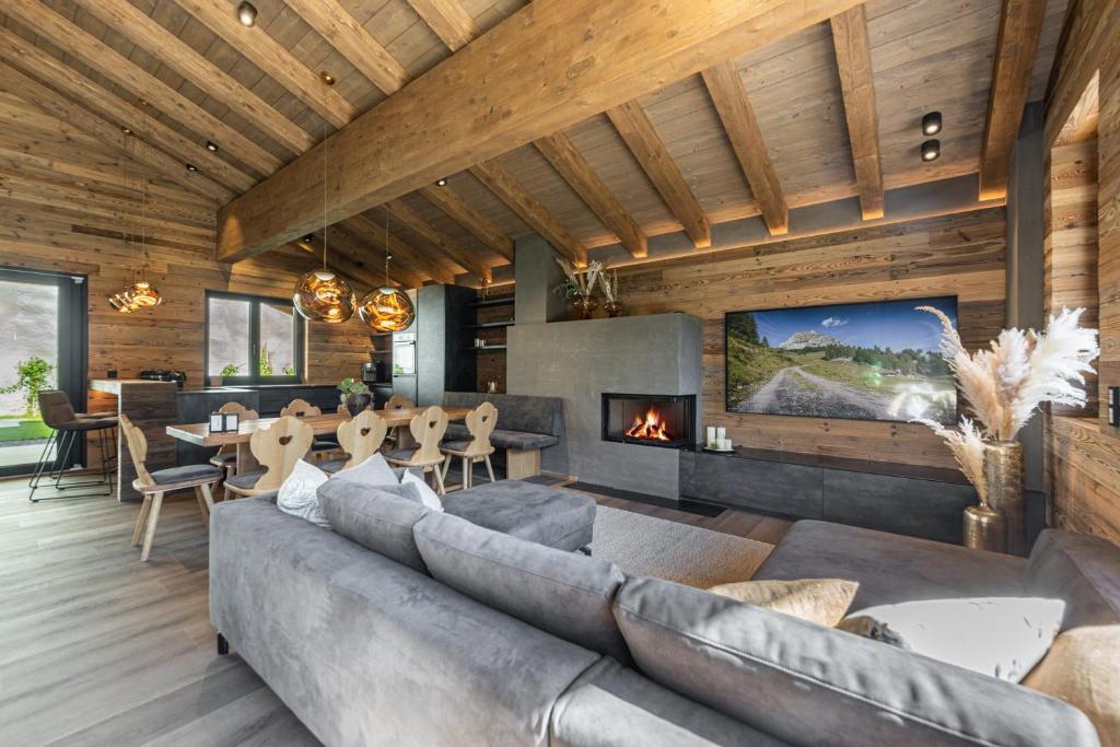 a living room with a couch and a fireplace at Kellnergut chalet Frieda in Mühlbach am Hochkönig