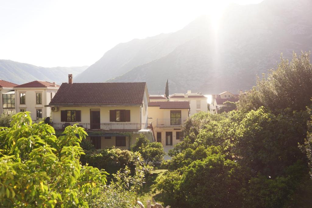 a group of houses in front of a mountain at Apartments Niković in Risan