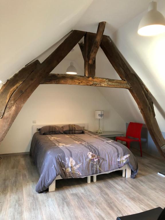 a bedroom with a bed in a attic at Le nid marin in Étretat