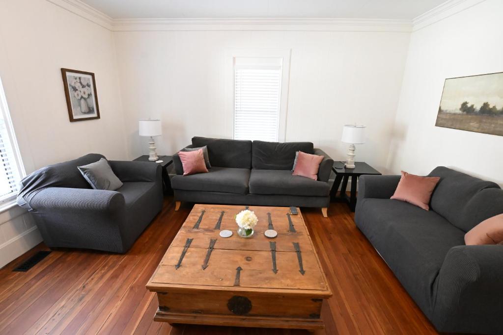 a living room with two couches and a coffee table at The Sago Palm House in Thomasville