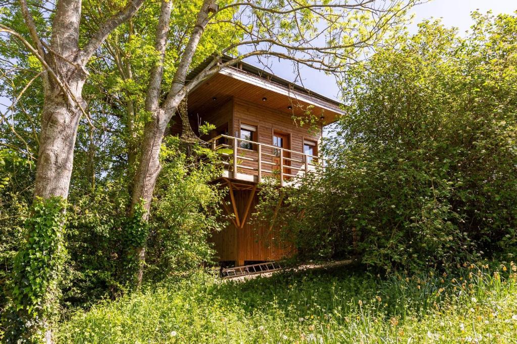 a wooden house in the middle of a forest at La Cabane Perchée in Vert