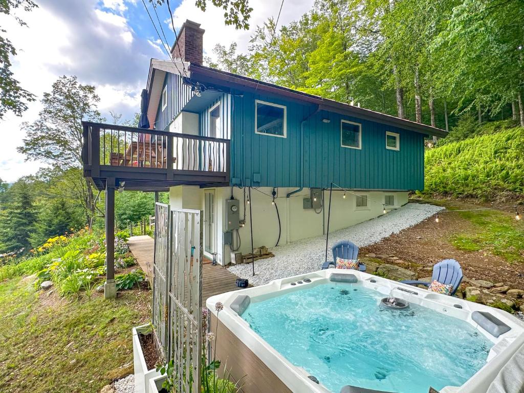 a house with a hot tub in front of it at Chalet Valhalla wHot Tub in Sugarbush Village