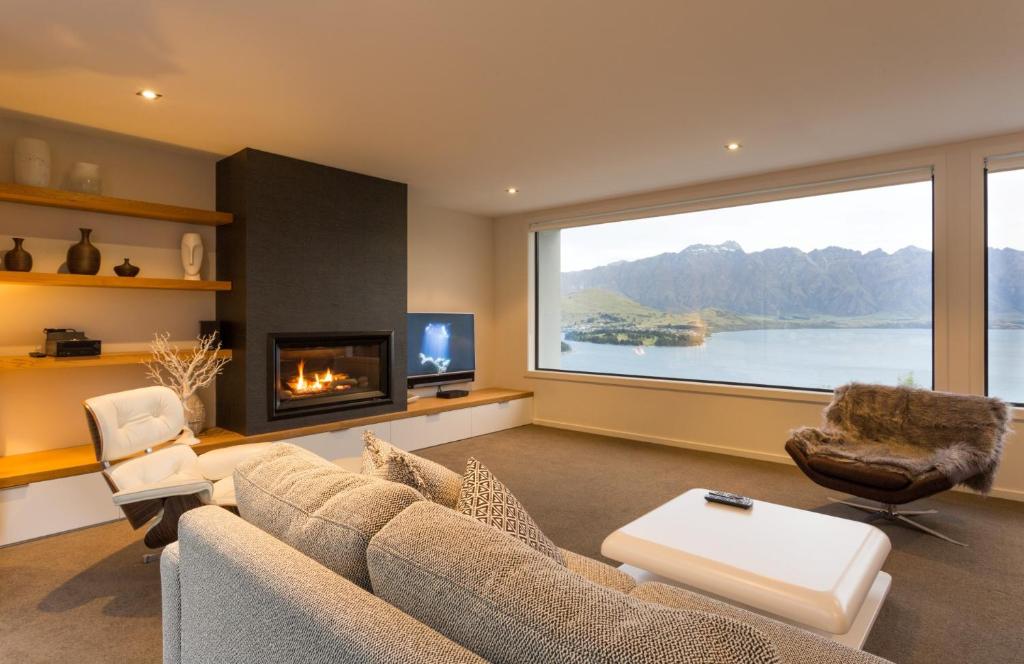 a living room with a couch and a fireplace at Fifteen by Amazing Accom in Queenstown