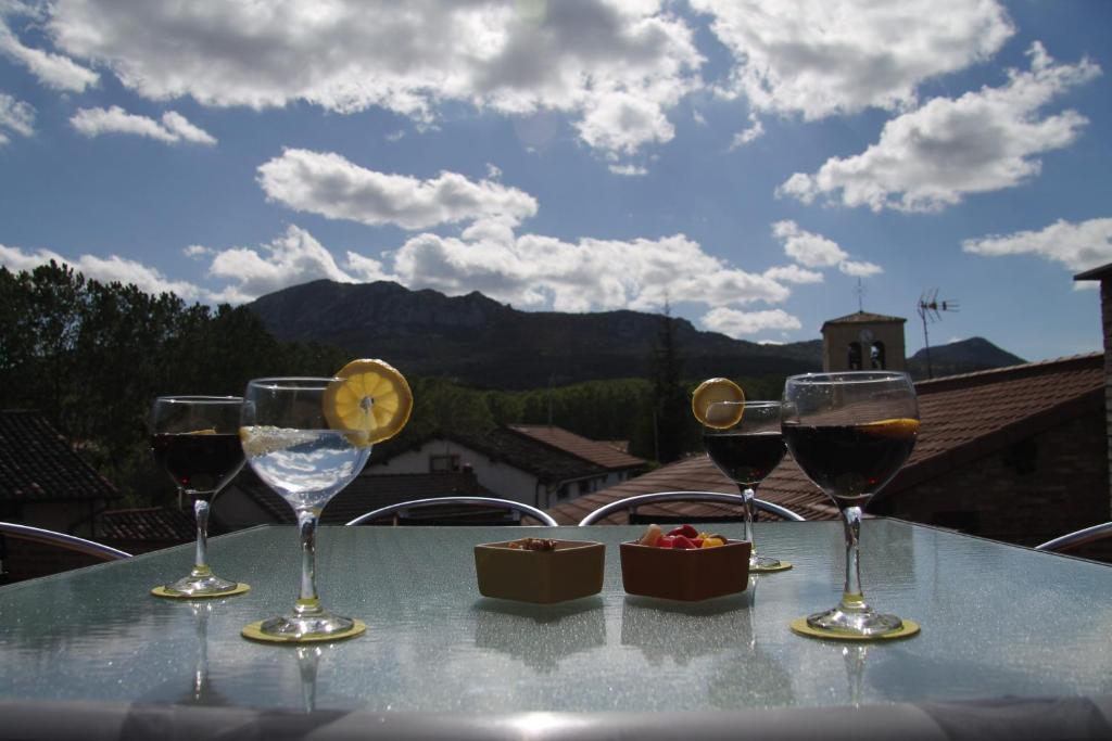 four wine glasses sitting on a table with a view at Areeta Etxea - Espejo in Espejo