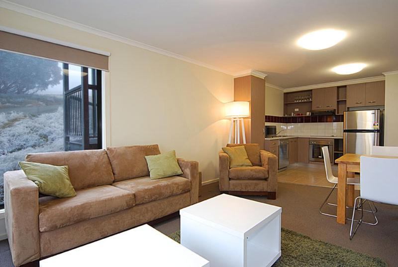 a living room with a couch and a kitchen at Higgi Drive 3 in Mount Hotham