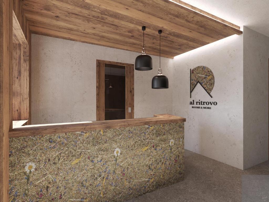 a room with a counter with a sign on the wall at al Ritrovo - rooms & more in Andalo