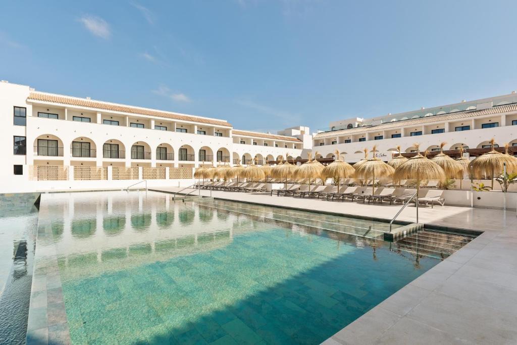 a large swimming pool in front of a building at Hotel Best Village Chipiona in Costa Ballena