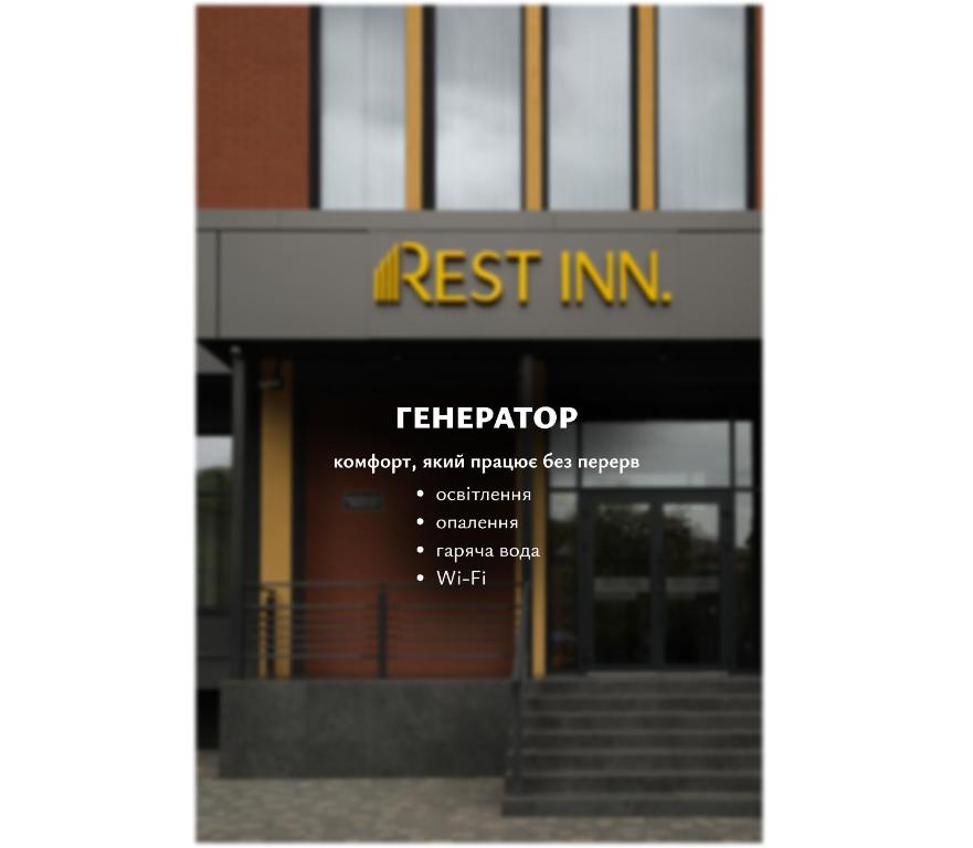a building with a sign that reads rest inn at REST INN apart hotel in Cherkasy