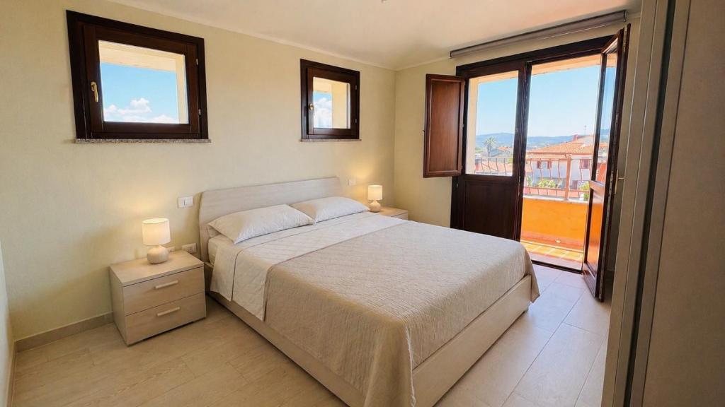 a bedroom with a bed and a large window at Aura Apartment in Senorbì