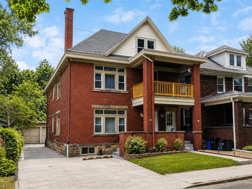 a brick house with a balcony on a street at Boulevard Park Apartments in Erie