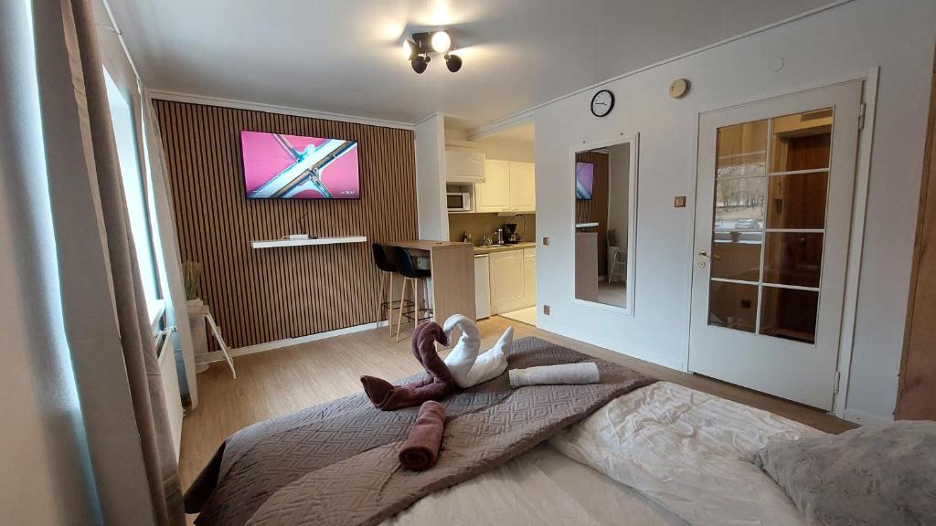 a bedroom with a bed with a stuffed animal on it at Modern studio apartment near the harbor and city center in Lappeenranta